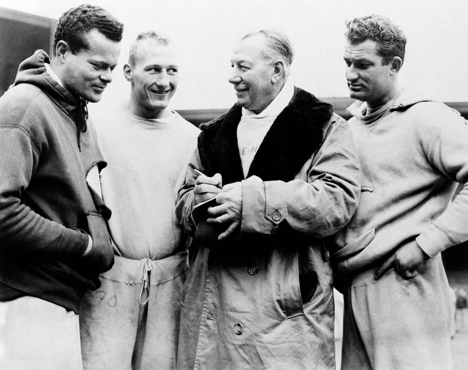 Coach Alfred Earle &quot;Greasy&quot; Neale, third from left, discusses a play, December 25, 1947 with three of his players in preparation for Sunday's National Football League Championship game with the Chicago Cardinals at Chicago. Listening while Neale explains the play's workings are, left to right, halfback Steve Van Buren, tackle Al Wistert and quarterback Tommy Thompson. (AP Photo)