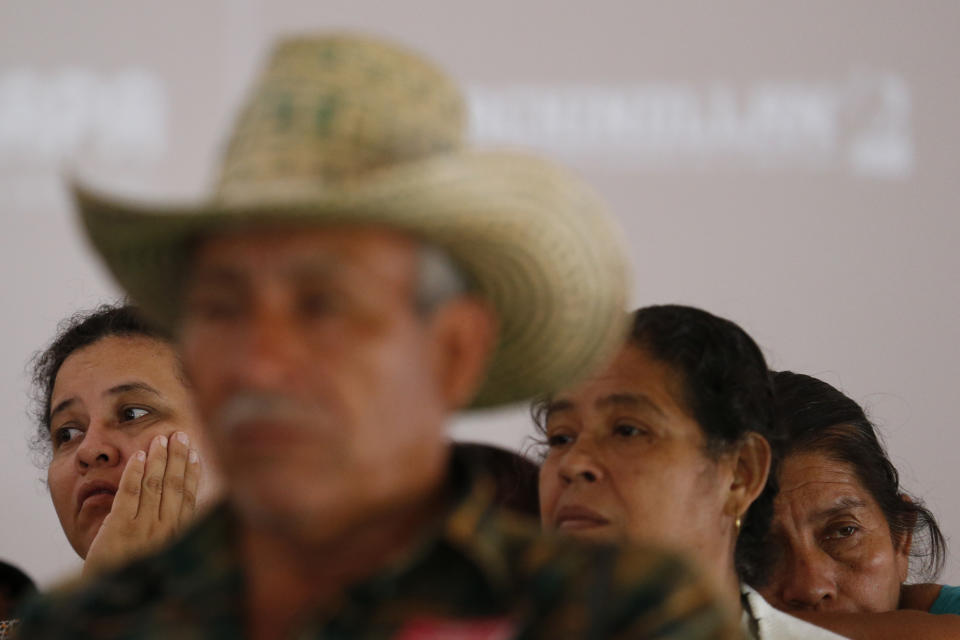 In this Sept. 11, 2019 photo, relatives of some of the 43 missing teacher's college students listen to other parents speak during a press conference following a private meeting they had with President Andres Manuel Lopez Obrador, in Mexico City. As the fifth anniversary of the students' disappearance at the hands of police approaches, relatives complained Wednesday that progress in the case has been too slow and some institutions are uncooperative. (AP Photo/Rebecca Blackwell)