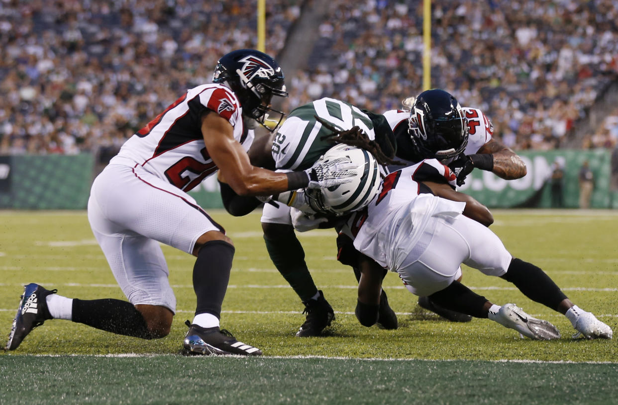 New York Jets running back Isaiah Crowell (20) breaks a tackle by Atlanta Falcons' Isaiah Oliver (20) to score a touchdown. No flags were thrown for an illegal hit on this play. (AP)