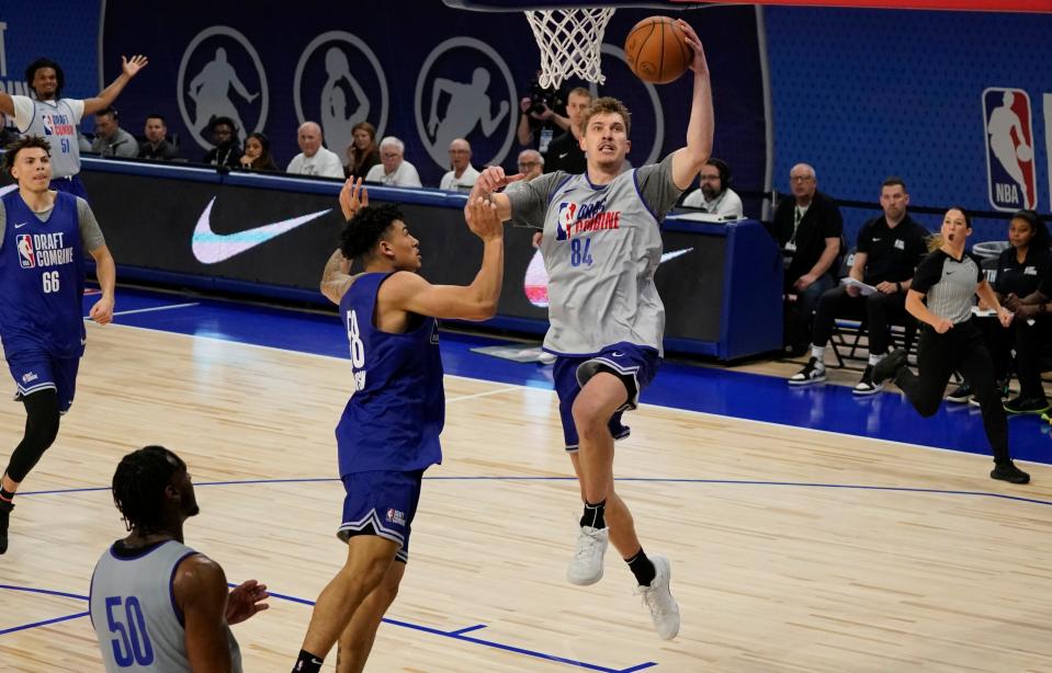Creighton's Baylor Scheierman drives on Colorado's KJ Simpson during a scrimmage at the 2024 NBA draft combine in Chicago. The two players led their respective teams in scoring in Tuesday's action.