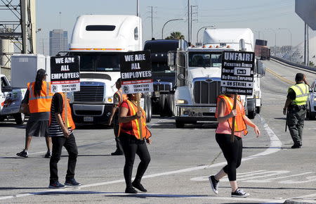 Striking trucker drivers and members of International Brotherhood of Teamsters walk the picket line at the Port of Long Beach in California, United States April 27, 2015. REUTERS/Bob Riha Jr.