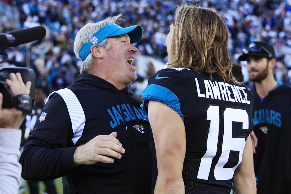 Jacksonville Jaguars head coach Doug Pederson celebrates with quarterback Trevor Lawrence (16) after the game of a regular season NFL football matchup Sunday, Dec. 18, 2022 at TIAA Bank Field in Jacksonville. The Jacksonville Jaguars edged the Dallas Cowboys 40-34 in overtime. [Corey Perrine/Florida Times-Union]