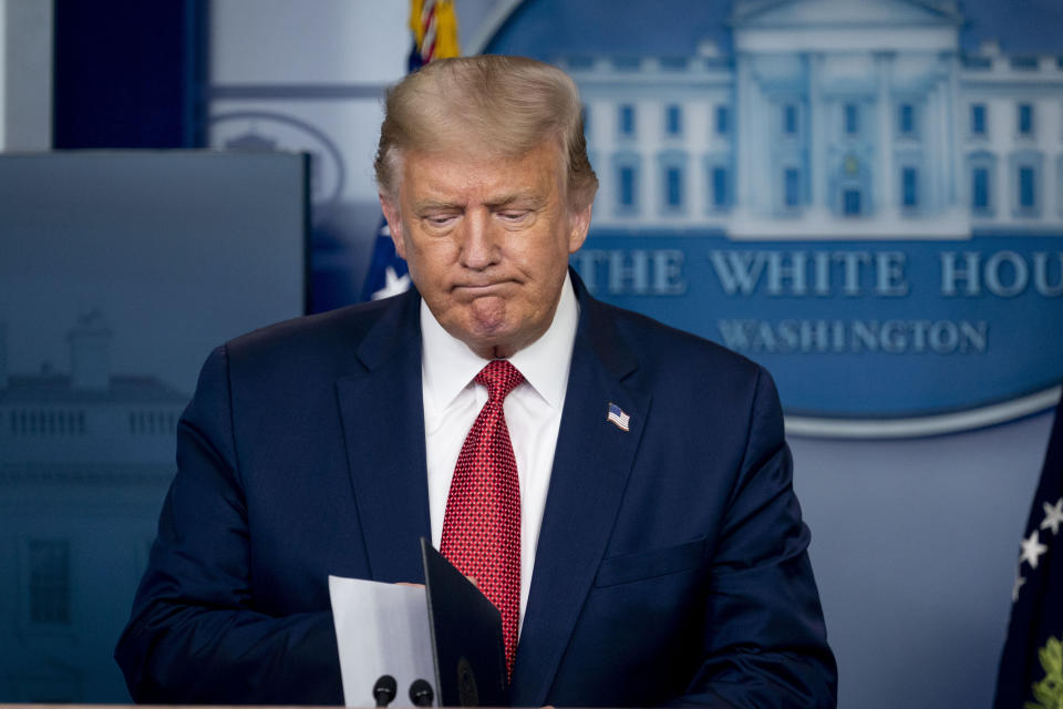 President Donald Trump returns to a news conference in the James Brady Press Briefing Room after he briefly left because of a security incident outside the fence of the White House, Monday, Aug. 10, 2020, in Washington. (AP Photo/Andrew Harnik)