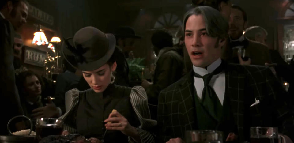 Winona Ryder and Keanu Reeves in period clothing at a formal dinner scene from the movie "Bram Stoker's Dracula."