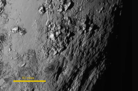 Ice mountains about 11,000 feet (3,500 meters) high — but no obvious craters — are visible in this photo, which was captured by NASA's New Horizons spacecraft on July 14, 2015 from a distance of 47,800 miles (77,000 kilometers).
