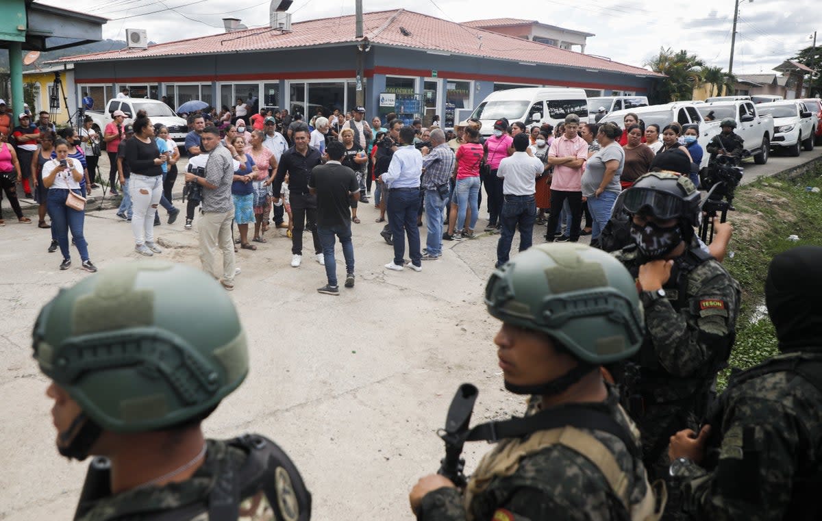Police guard the entrance to the women's prison in Tamara, on the outskirts of Tegucigalpa, Honduras (AP)