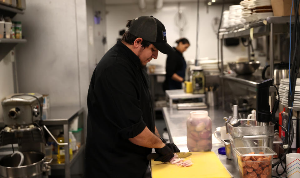 BOSTON, MA - FEBRUARY 24: An employee works in the kitchen at Democracy Brewing.  Implementation of restaurants 