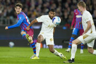 Barcelona's Gavi, left, takes a shot at goal as A-League All Stars' Adrian Mariappa watches during their friendly soccer match at Stadium Australia in Sydney, Australia, Wednesday, May 25, 2022. (AP Photo/Rick Rycroft)