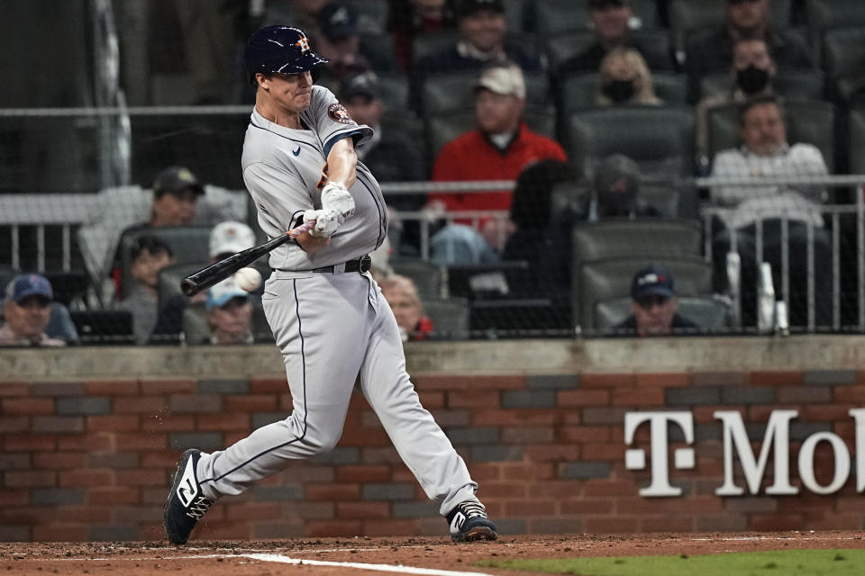 Houston Astros' Zack Greinke hits a single during the second inning in Game 4 of baseball's World Series between the Houston Astros and the Atlanta Braves Saturday, Oct. 30, 2021, in Atlanta. (AP Photo/David J. Phillip)