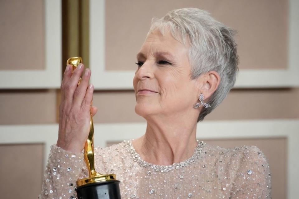 Jamie Lee Curtis holding her Oscar statue