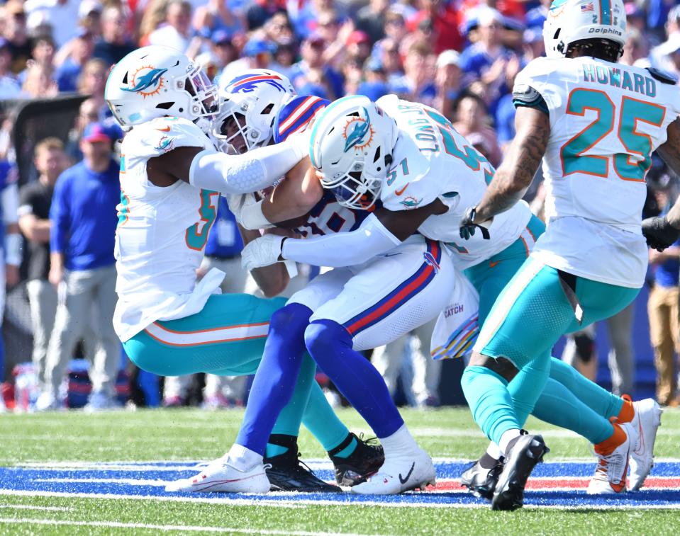 Oct 1, 2023; Orchard Park, New York, USA; Miami Dolphins linebacker Jerome Baker (55) and linebacker David Long Jr. (51) make a tackle on Buffalo Bills tight end Dalton Kincaid (86) in the first quarter at Highmark Stadium. Mandatory Credit: Mark Konezny-USA TODAY Sports