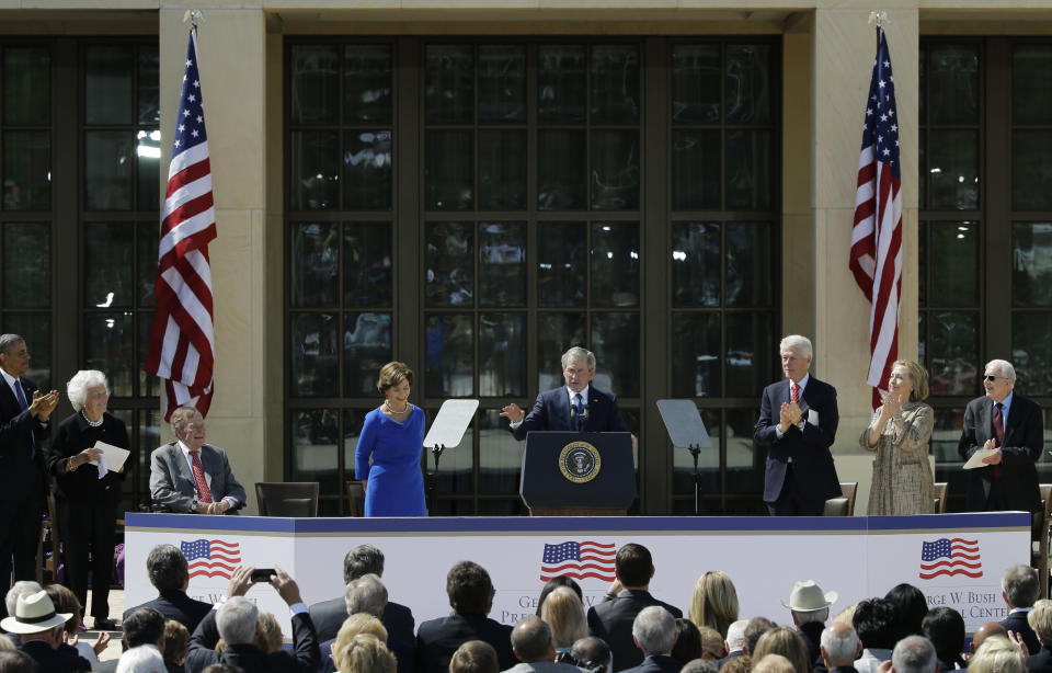 From left, President Barack Obama, former first lady Barbara Bush, President George H.W. Bush, former first lady Laura Bush, former president William J. Clinton, former first lady Hillary Clinton and former president Jimmy Carter applaud former president George W. Bush during the dedication of the George W. Bush presidential library on Thursday, April 25, 2013, in Dallas. (AP Photo/David J. Phillip)