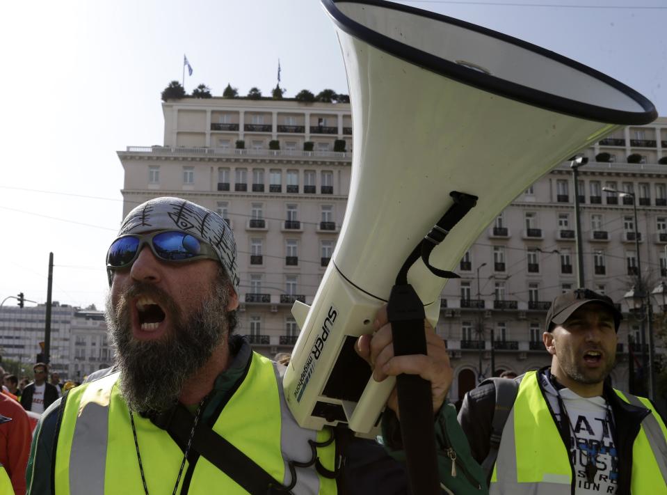 Protesters shout slogans during a rally by hundreds of striking port workers outside the Greek Parliament in Athens, on Tuesday, April 8, 2014. Greek dock workers across the country walked off the job Tuesday in a 48-hour strike to protest plans to sell stakes of the Piraeus Port Authority, the country's largest port and Thessaloniki port. Greece's Finance Ministry says the lower cost and stronger investor appetite for the country's latest short-term debt issue bodes well for a planned return to bond markets in coming months. (AP Photo/Thanassis Stavrakis)