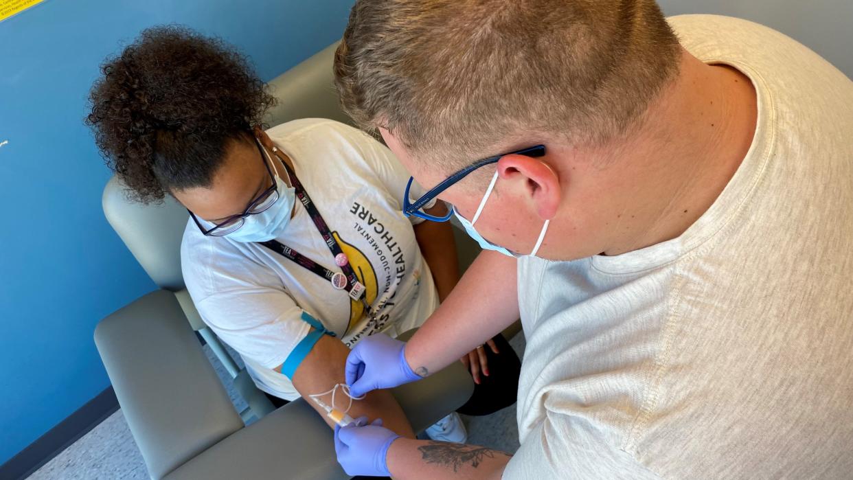 Program manager Shane Barrera provides a medical screening for a patient at the Southwest Center.