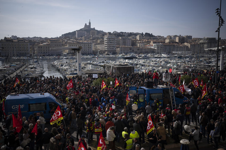 Protesters gather during a demonstration in Marseille, southern France, Tuesday, March 7, 2023. Garbage collectors, utility workers and train drivers are among people walking off the job Tuesday across France. They are expressing anger at a bill raising the retirement age to 64, which unions see as a broader threat to the French social model. (AP Photo/Daniel Cole)