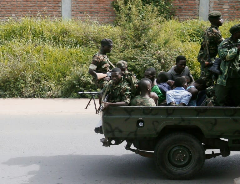 A military vehicle, carrying men tied up, drives through the Musaga neighbourhood of the city of Bujumbura on December 11, 2015