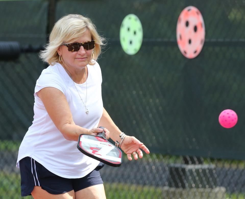 Jennie Parrish plays pickleball against her friend Harry "Hop" Delp at Stadium Park in Canton.