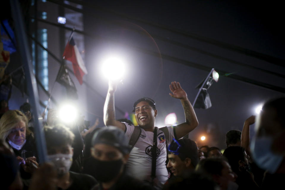 People gather at Plaza Italia on the day Chileans voted in a referendum to decide whether the country should replace its 40-year-old constitution, written during the dictatorship of Gen. Augusto Pinochet, in Santiago, Sunday, Oct. 25, 2020. (AP Photo/Luis Hidalgo)