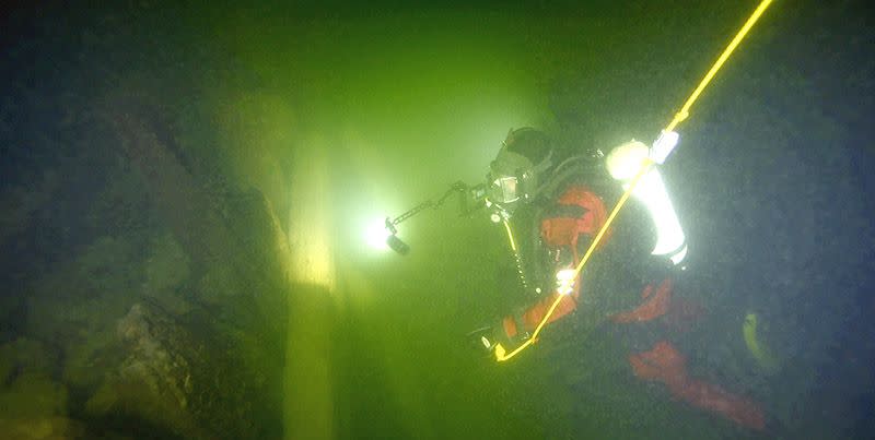 diver approaches applet sunken warship