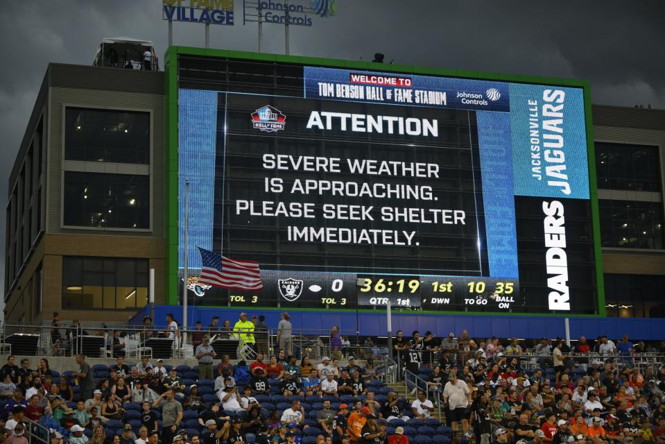 A severe weather warning is displayed on the scoreboard at Tom Benson Hall of Fame Stadium in Canton, Ohio, before the Hall of Fame exhibition NFL football game between the Jaguars and the Las Vegas Raiders. The game was delayed 40 minutes.