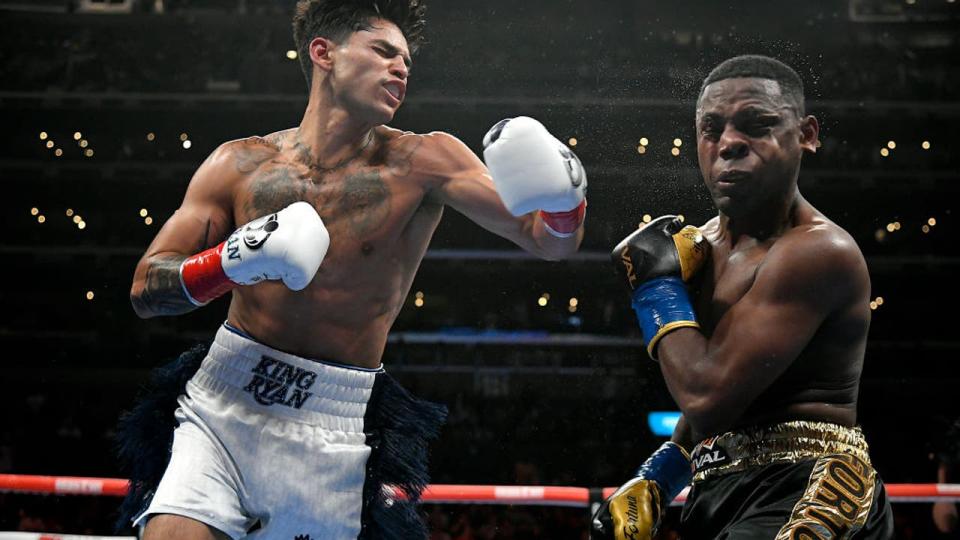 <div>LOS ANGELES, CA - JULY 16: Ryan Garcia (white trunks) lands a punt on Javier Fortuna in the fourth round at the Crypto.com Arena on July 16, 2022 in Los Angeles, United States. (Photo by John McCoy/Getty Images)</div>