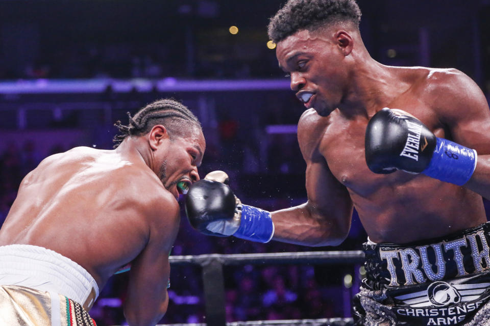 Errol Spence Jr. , right, lands a punch against Shawn Porter during the WBC & IBF World Welterweight Championship boxing match Saturday, Sept. 28, 2019, in Los Angeles. (AP Photo/Ringo H.W. Chiu)