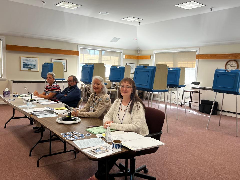 Poll workers await voters at Portsmouth Town Hall Tuesday morning.