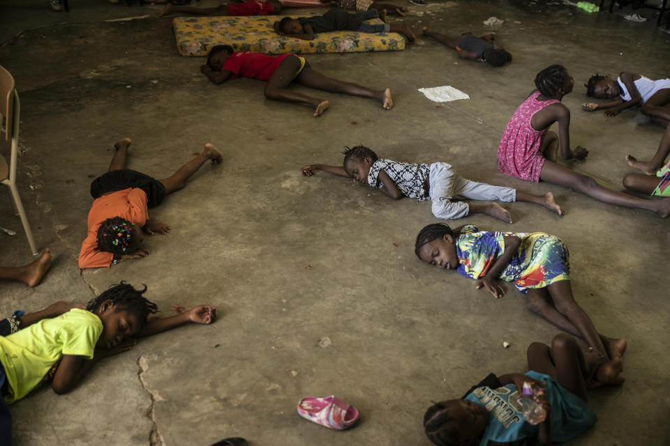 Children sleep on the floor of a school turned into a shelter after they were forced to leave their homes in Cite Soleil due to clashes between armed gangs, in Port-au-Prince, Haiti, Saturday, July 23, 2022. (AP Photo/Odelyn Joseph)