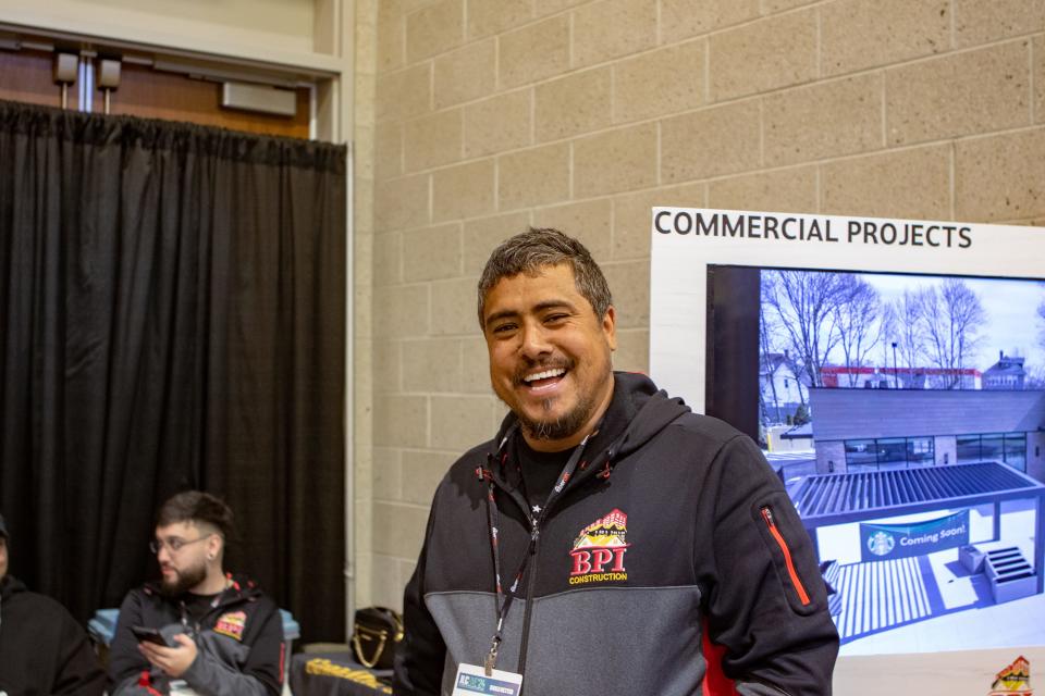Ramon Costa works the booth for his family's construction company at the JLC Live Residential Construction Show.