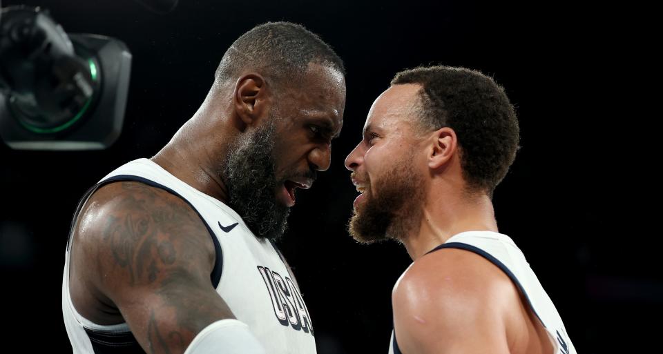 PARIS, FRANCE – AUGUST 08: Lebron James #6 and Stephen Curry #4 of Team USA celebrate after their team's victory against Team Serbia during a men's basketball semifinal game between Team USA and Team Serbia on the thirteenth day of the Paris 2024 Olympic Games at Bercy Arena on August 8, 2024 in Paris, France. (Photo by Gregory Shamus/Getty Images)