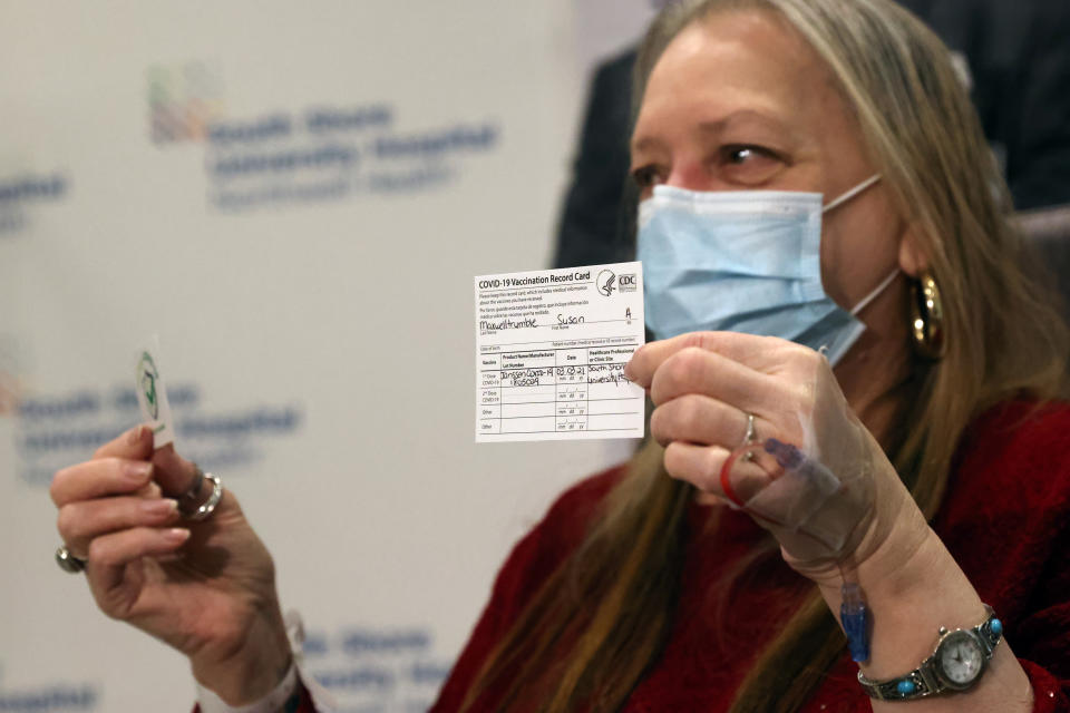 BAY SHORE, NEW YORK - MARCH 03: Susan Maxwell-Trumble holds up a vaccination card at South Shore University Hospital after receiving the Johnson & Johnson COVID-19 vaccine on March 03, 2021 in Bay Shore, New York. The new vaccine from the American pharmaceutical company is a single shot vaccine that has shown 85 percent protection against severe disease and can be stored at regular refrigeration temperatures. (Photo by Spencer Platt/Getty Images)