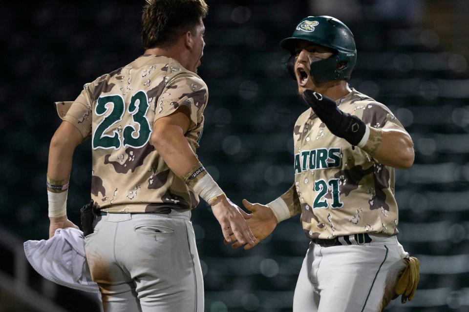 Island Coast's Kevin Martinez (21) scores in the top of the fifth inning of the FHSAA baseball Class 4A state championship between Island Coast High School (Cape Coral) and Jensen Beach High School, Tuesday, May 24, 2022, at Hammond Stadium in Fort Myers, Fla.Island Coast defeated Jensen Beach 8-7 in eight innings.