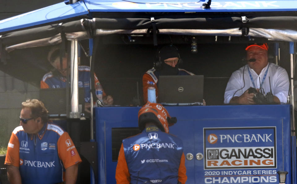 Car owner Chip Ganassi, right, sits in the pit box on pit road during an IndyCar race at Mid-Ohio Sports Car Course in Lexington, Ohio, Sunday, July 4, 2021. (AP Photo/Tom E. Puskar)