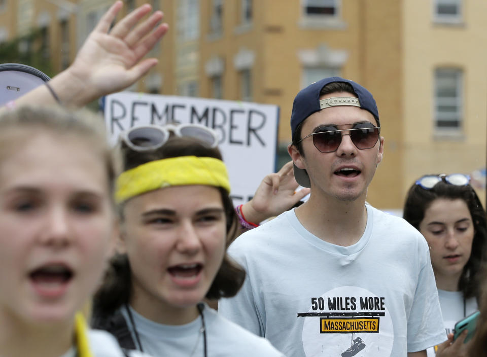 David Hogg, center right, a survivor of the school shooting at Marjory Stoneman Douglas High School, in Parkland, Fla., walks in a planned 50-mile march, Thursday, Aug. 23, 2018, in Worcester, Mass. The march, held to call for gun law reforms, began Thursday, in Worcester, and is scheduled to end Sunday, Aug. 26, 2018, in Springfield, Mass., at the headquarters of gun manufacturer Smith & Wesson. (AP Photo/Steven Senne)