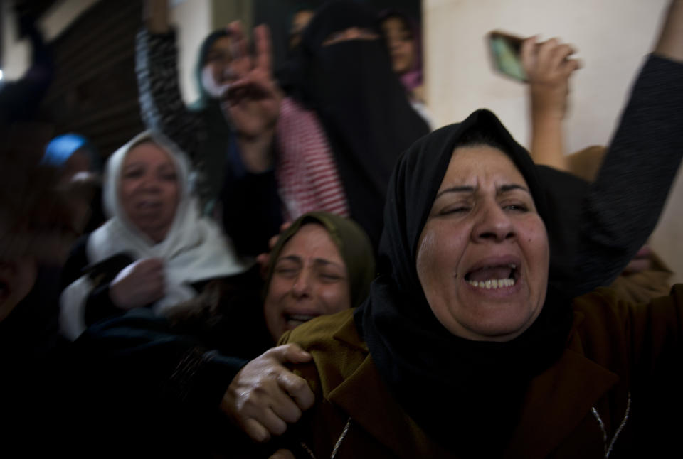 Relatives of Palestinian woman, Amal al-Taramsi, 43, who was killed by Israeli troops during Friday's protest at the Gaza Strip's border with Israel, mourn during her funeral in Gaza City, Saturday, Jan. 12, 2019. (AP Photo/Khalil Hamra)