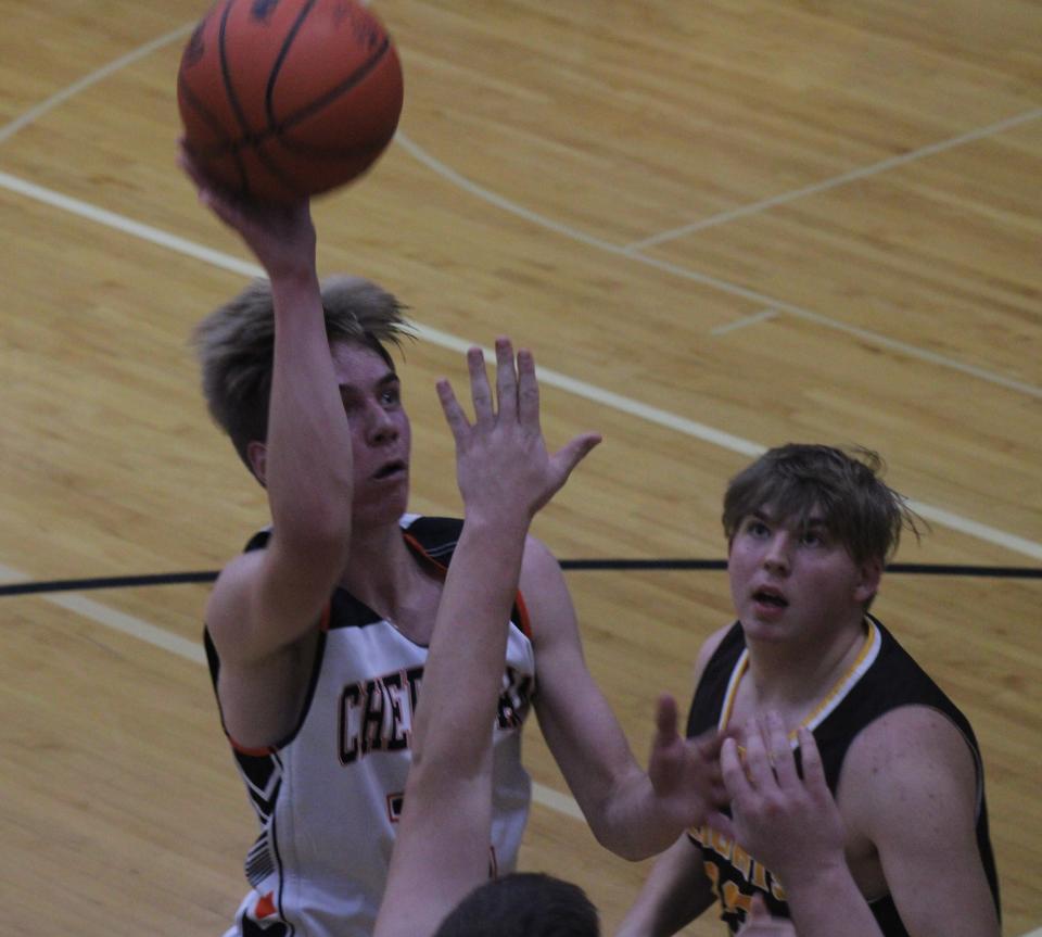 Cheboygan junior guard Brennen Thater gets ready to take a shot over a pair of Ogemaw defenders during the first half of Tuesday's home basketball opener in Cheboygan.