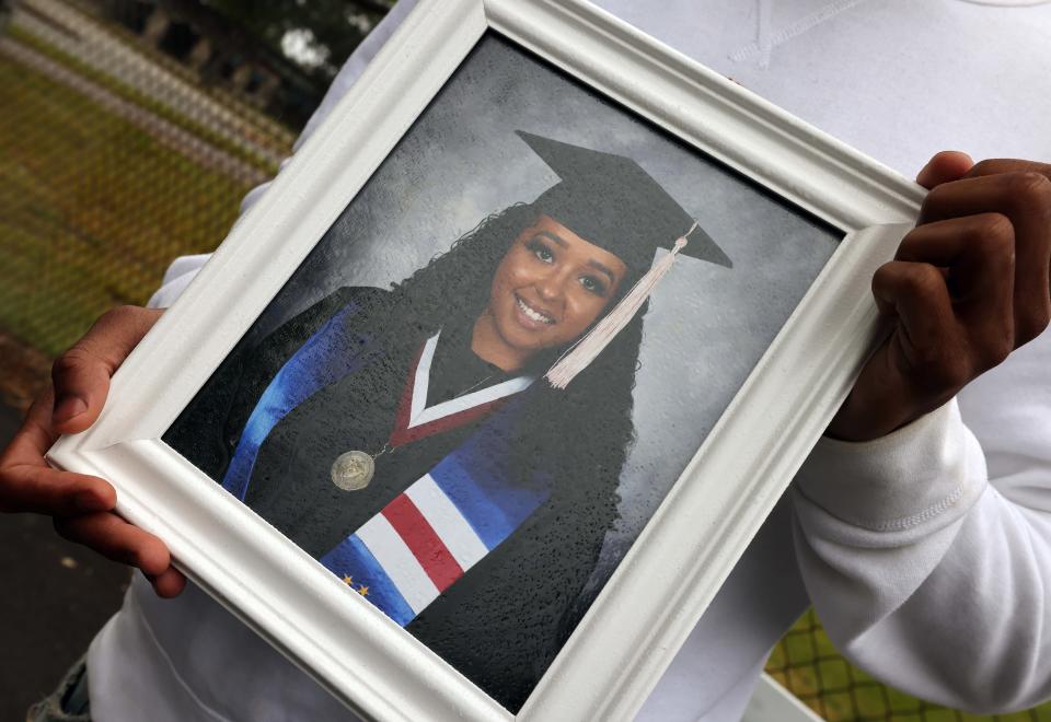 Jonathan Rodrigues holds a photograph of his cousin, the late Ashley Cardoso, at East Middle School in Brockton on Saturday, June 3, 2023.