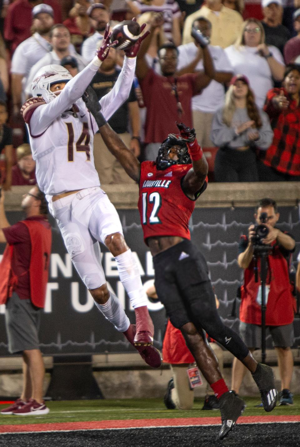 Florida State's Johnny Wilson hauls in a touchdown pass against Louisville's Jarvis Brownlee. Sept. 16, 2022