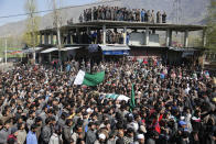 Kashmiri villagers carry the body of of Umer Farooq, a Kashmiri civilian who was killed Sunday during his funeral at Baroosa village 34 Kilometers (21 miles) northeast of Srinagar, Indian controlled Kashmir, Monday, April 10, 2017. Government forces opened fire on Sunday on crowds of people who attacked polling stations during a by-election for a vacant seat in India's Parliament, killing eight people. (AP Photo/Mukhtar Khan)