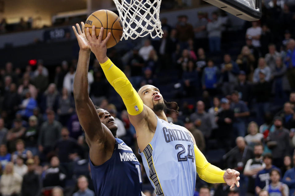 Memphis Grizzlies forward Dillon Brooks (24) shoots in front of Minnesota Timberwolves guard Anthony Edwards (1) in the first quarter of an NBA basketball game Wednesday, Nov. 30, 2022, in Minneapolis. (AP Photo/Andy Clayton-King)