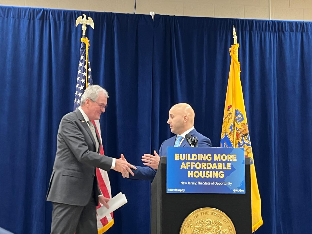Gov. Phil Murphy shakes hands with Perth Amboy Mayor Helmin Caba before Murphy signed a bill overhauling the state's affordable housing system Wednesday.