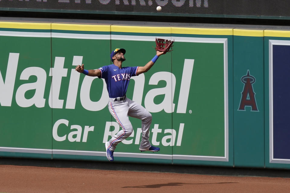 Texas Rangers center fielder Leody Taveras makes a catch on a ball hit by Los Angeles Angels' Luis Rengifo during the seventh inning of a baseball game Sunday, July 31, 2022, in Anaheim, Calif. (AP Photo/Mark J. Terrill)