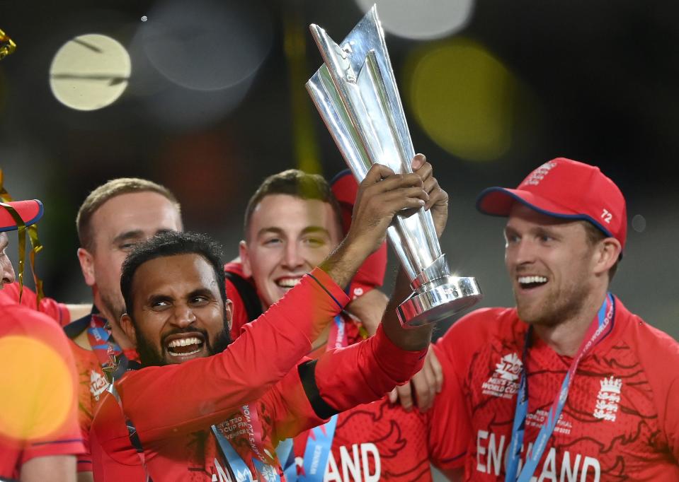 Adil Rashid and his English teammates celebrate with the ICC Men's T20 World Cup Trophy after winning the ICC Men's T20 World Cup Final match between Pakistan and England at the Melbourne Cricket Ground on November 13, 2022 in Melbourne, Australia.
