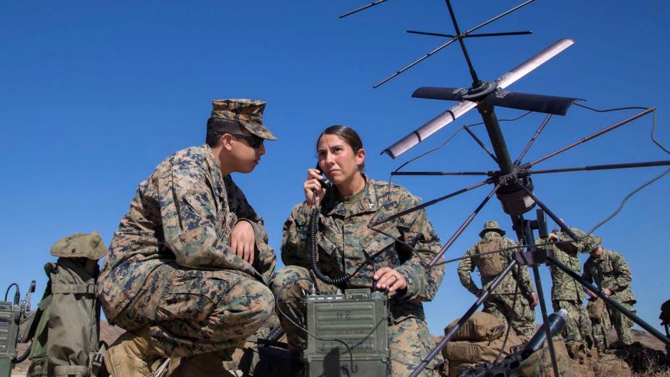 U.S. Marine Corps Cpl. Ashley Arentz, right, and Lance Cpl. Theodore Brooks set up a portable radio communications radio at the helicopter outlying landing facility on Camp Pendleton, Calif., during the 2017 exercise Dawn Blitz. (Lance Cpl. Roderick Jacquote/U.S. Marine Corps)