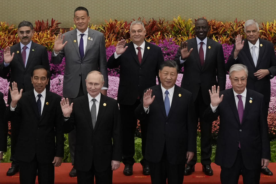 From left in front row, Indonesian President Joko Widodo, Russian President Vladimir Putin, Chinese President Xi Jinping and Kazakhstan President Kassym-Jomart Tokayev with other leaders wave during a group photo session at the Belt and Road Forum in Beijing Wednesday, Oct. 18, 2023. (Suo Takekuma/Pool Photo via AP)