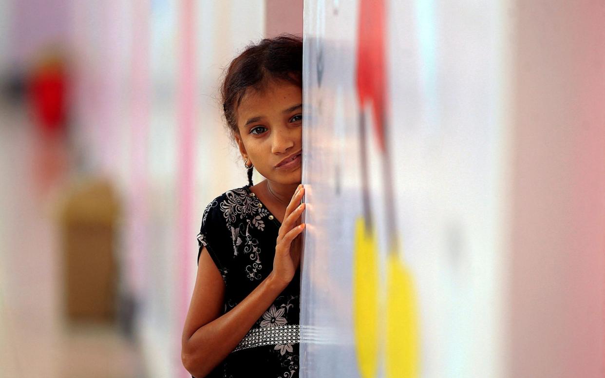 A girl looks on at the malnutrition ward of al-Sabeen Maternity and Child Hospital in the Huthi-rebel-held Yemeni capital Sanaa, - Mohammed Huwais/AFP