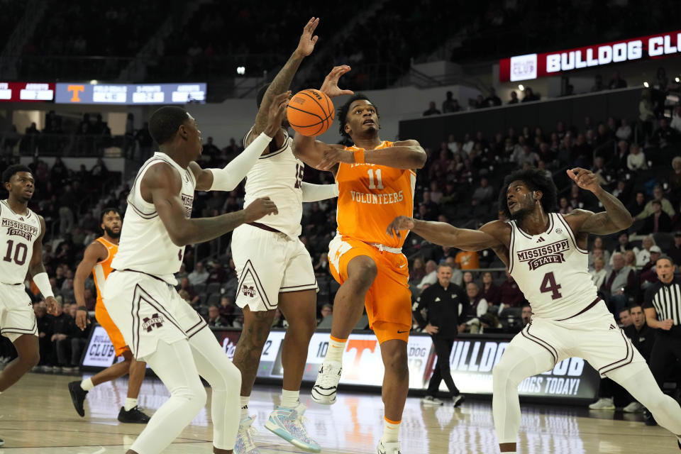 Tennessee forward Tobe Awaka (11) attempts a layup with Mississippi State forwards Cameron Matthews (4) and Jimmy Bell Jr. (15) defending during the first half of an NCAA college basketball game, Wednesday, Jan. 10, 2024, in Starkville, Miss. (AP Photo/Rogelio V. Solis)