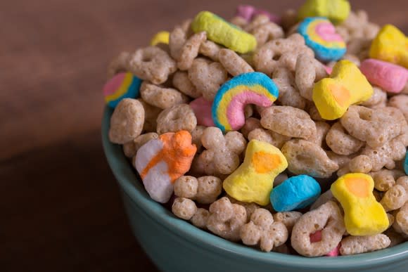 Cereal in a blue bowl on a wood table.