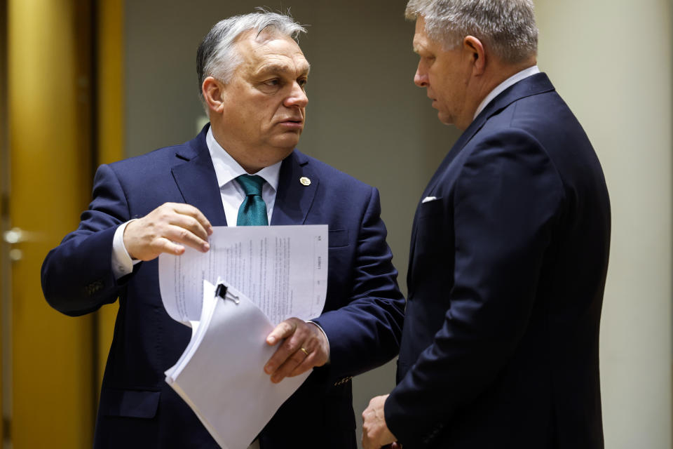 Slovakia's Prime Minister Robert Fico, right, talks to Hungary's Prime Minister Viktor Orban during a round table meeting at an EU summit in Brussels, Thursday, Feb. 1, 2024. European Union leaders meet in Brussels for a one day summit to discuss the revision of the Multiannual Financial Framework 2021-2027, including support for Ukraine. (AP Photo/Geert Vanden Wijngaert)