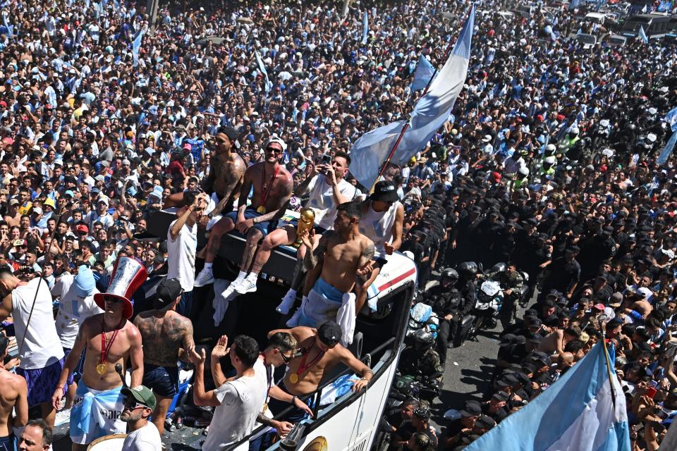 Argentina's players celebrate on board a bus with a sign reading 